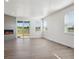 Open-concept living room featuring a modern fireplace and sliding glass doors at 1850 Sawtooth Mountain Dr, Berthoud, CO 80513