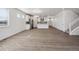Spacious living area showcasing the kitchen with an island and staircase at 1850 Sawtooth Mountain Dr, Berthoud, CO 80513