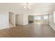 Open living area with wood-look floors, a modern fireplace, and access to a staircase and other rooms at 1850 Sawtooth Mountain Dr, Berthoud, CO 80513