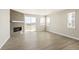 Spacious living room featuring modern flooring, a stylish fireplace, and ample natural light from large windows at 1850 Sawtooth Mountain Dr, Berthoud, CO 80513