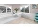 Luxurious bathroom with a soaking tub and large windows at 8047 S Fairfax Ct, Centennial, CO 80122