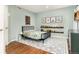 Cozy bedroom features leafy decor, hardwood floors, and shelving filled with ' books at 8047 S Fairfax Ct, Centennial, CO 80122