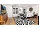 Cozy bedroom featuring light wood floors, a black and white rug, and modern decor at 8047 S Fairfax Ct, Centennial, CO 80122
