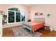Bright bedroom with a large arched window, hardwood floors, and a playful, charming atmosphere at 8047 S Fairfax Ct, Centennial, CO 80122
