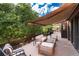 Back deck with awning featuring a seating arrangement, grill and views of the greenery at 8047 S Fairfax Ct, Centennial, CO 80122