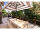 Outdoor dining set under a striped umbrella on a deck with views of surrounding trees at 8047 S Fairfax Ct, Centennial, CO 80122