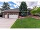 Charming brick home with a well-manicured lawn and a spacious two-car garage at 8047 S Fairfax Ct, Centennial, CO 80122
