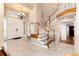 Inviting foyer with tile floors, a grand staircase, and an elegant chandelier at 8047 S Fairfax Ct, Centennial, CO 80122