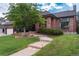 Beautiful brick home with a curved walkway and manicured landscaping at 8047 S Fairfax Ct, Centennial, CO 80122