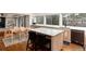 Open kitchen design with breakfast bar, counter seating, and hardwood floors at 8047 S Fairfax Ct, Centennial, CO 80122