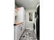 Charming laundry room with modern appliances, ample cabinet space, and stylish tiled floor at 8047 S Fairfax Ct, Centennial, CO 80122