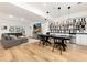 Basement living room and dining area with modern decor and ample space for entertaining at 8047 S Fairfax Ct, Centennial, CO 80122