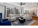 Open living area flows to kitchen; features hardwood flooring and large windows at 8047 S Fairfax Ct, Centennial, CO 80122