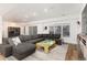 Spacious living room with a large sectional sofa, a decorative rug, and ample natural light at 8047 S Fairfax Ct, Centennial, CO 80122