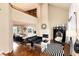 Bright living area featuring a fireplace, high ceilings, and an open floor plan at 8047 S Fairfax Ct, Centennial, CO 80122