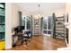 Bright office with large windows, hardwood floors, modern lighting, and built-in shelving at 8047 S Fairfax Ct, Centennial, CO 80122