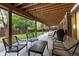 Covered outdoor patio with seating area, grill, and view of the backyard at 8047 S Fairfax Ct, Centennial, CO 80122
