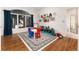 Playroom features hardwood floors, large window, and plenty of storage at 8047 S Fairfax Ct, Centennial, CO 80122