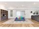 Bright playroom with a modular sofa, large rug, hardwood floors, and a cozy atmosphere at 8047 S Fairfax Ct, Centennial, CO 80122