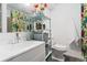 Bright bathroom features shelving, laminate floors, and colorful, plant-themed decor at 6621 E Peakview Pl, Centennial, CO 80111