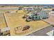 An aerial view showcases the expansive yard, deck, and play area, complete with fencing at 16360 Paris Way, Brighton, CO 80602
