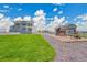 Beautiful backyard features a playground and a large lawn, ideal for outdoor enjoyment and Gathering activities at 16360 Paris Way, Brighton, CO 80602