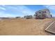 Expansive fenced backyard with sheds, offering ample space for outdoor activities and storage at 16360 Paris Way, Brighton, CO 80602