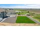 Aerial view showcases a large, well-maintained backyard, a playground and lush green grass with stunning views of the open land at 16360 Paris Way, Brighton, CO 80602