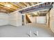 Unfinished basement showing open layout, exposed beams, and stairs to upper level at 16360 Paris Way, Brighton, CO 80602
