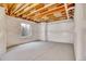 Unfinished basement with a window, wrapped walls, and concrete floor ready for renovation at 16360 Paris Way, Brighton, CO 80602