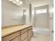 Bathroom with granite countertops, tiled floors and shower, and a large mirror at 16360 Paris Way, Brighton, CO 80602