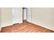 Bedroom with wood floors showcasing two closets/doorways in a neutral toned room at 16360 Paris Way, Brighton, CO 80602