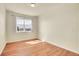 Bright bedroom with wood floors and large window illuminating the room at 16360 Paris Way, Brighton, CO 80602