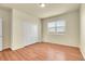 Light-filled bedroom featuring wood floors, a closet, and a large window at 16360 Paris Way, Brighton, CO 80602
