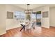 A cozy dining area featuring stylish lighting, a dining table, and large windows with scenic views at 16360 Paris Way, Brighton, CO 80602