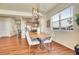 Charming dining area showcasing modern lighting, a stylish table, and seamless access to the kitchen at 16360 Paris Way, Brighton, CO 80602