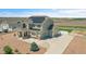 Aerial view of home with three-car garage, solar panels, well-manicured lawn, and fenced perimeter at 16360 Paris Way, Brighton, CO 80602