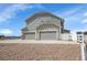 Attractive two-story home featuring a three-car garage and low-maintenance landscaping at 16360 Paris Way, Brighton, CO 80602