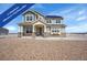 Charming two-story home with a welcoming front porch, solar panels, and a beautifully graveled front yard at 16360 Paris Way, Brighton, CO 80602