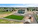 Lovely two-story home boasts a large green lawn, gravel landscaping, and a playground, creating an inviting outdoor space at 16360 Paris Way, Brighton, CO 80602