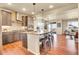 Modern kitchen with stainless steel appliances, large island with seating, and stylish pendant lighting at 16360 Paris Way, Brighton, CO 80602