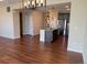 Open floor plan displays kitchen and dining area, stainless steel appliances, and wooden floors at 16360 Paris Way, Brighton, CO 80602