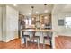 Well-lit kitchen features stainless steel appliances, an island with seating, and stylish modern pendant lighting at 16360 Paris Way, Brighton, CO 80602