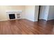 Bright living room features a fireplace, wood floors, and neutral paint colors at 16360 Paris Way, Brighton, CO 80602