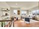 A modern living room showcases recessed lighting, lots of light and seating, and stylish decor at 16360 Paris Way, Brighton, CO 80602