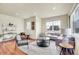A modern living room showcases recessed lighting, lots of light and seating, and stylish decor at 16360 Paris Way, Brighton, CO 80602