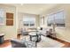 A modern living room is bright and inviting with large windows and comfortable seating for relaxing or entertaining at 16360 Paris Way, Brighton, CO 80602