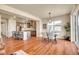 Bright open living space with hardwood floors, large kitchen island and a charming dining area at 16360 Paris Way, Brighton, CO 80602