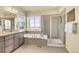 A stylish main bathroom featuring double sinks, a soaking tub, a glass-enclosed shower, and great natural light at 16360 Paris Way, Brighton, CO 80602