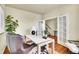 Home office featuring a large desk, chair, wood floors and natural light at 16360 Paris Way, Brighton, CO 80602